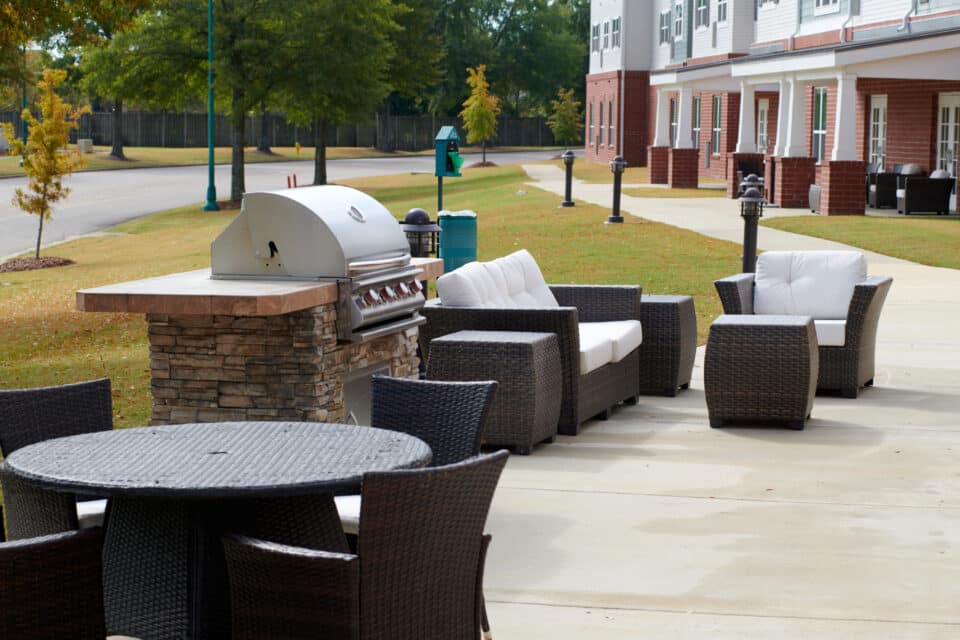 outside patio with grill, couches and chairs